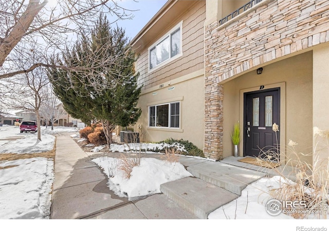 view of snow covered property entrance