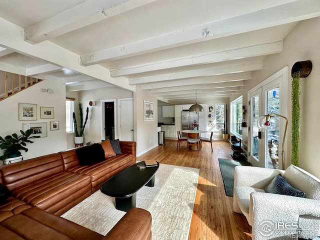 living room with beamed ceiling and hardwood / wood-style floors