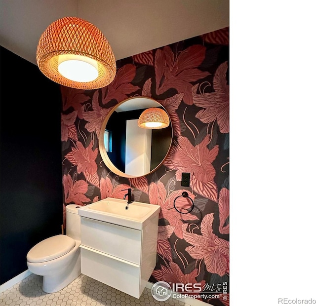 bathroom featuring tile patterned floors, vanity, and toilet