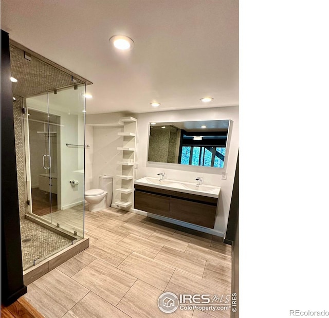 bathroom featuring walk in shower, vanity, and toilet