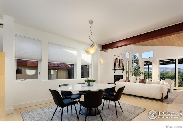 dining area featuring hardwood / wood-style flooring and lofted ceiling with beams