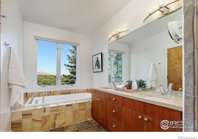 bathroom featuring vanity and a relaxing tiled tub