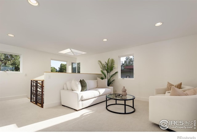 living room with light carpet and a skylight