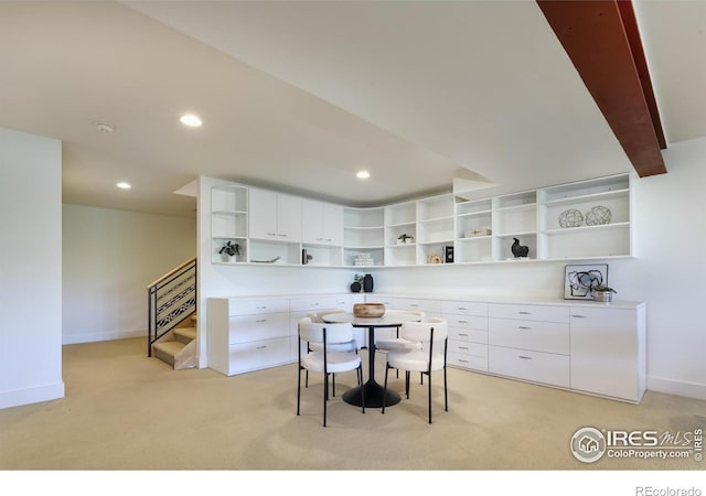 dining area featuring light carpet