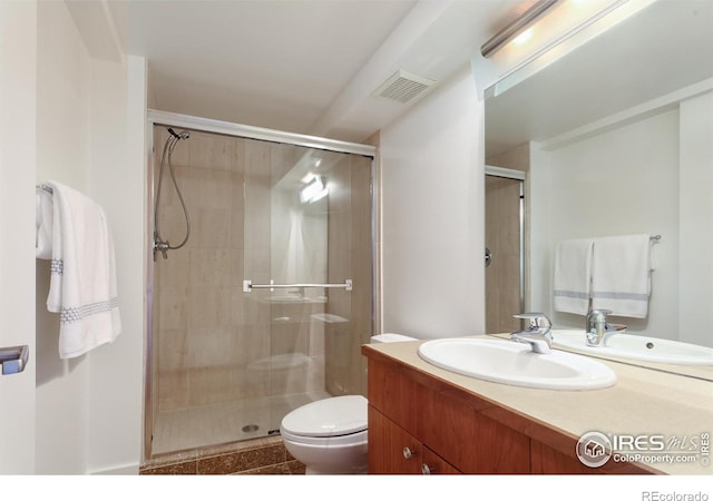 bathroom with walk in shower, vanity, and toilet