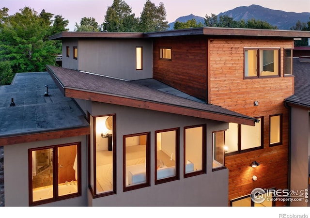 back house at dusk featuring a mountain view