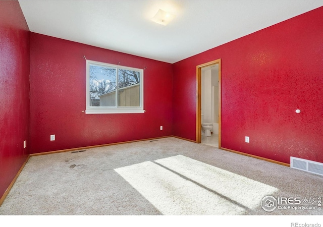 spare room featuring carpet