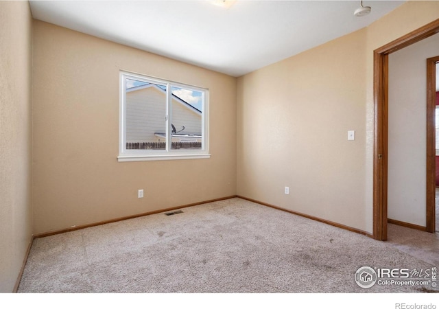 empty room with light colored carpet