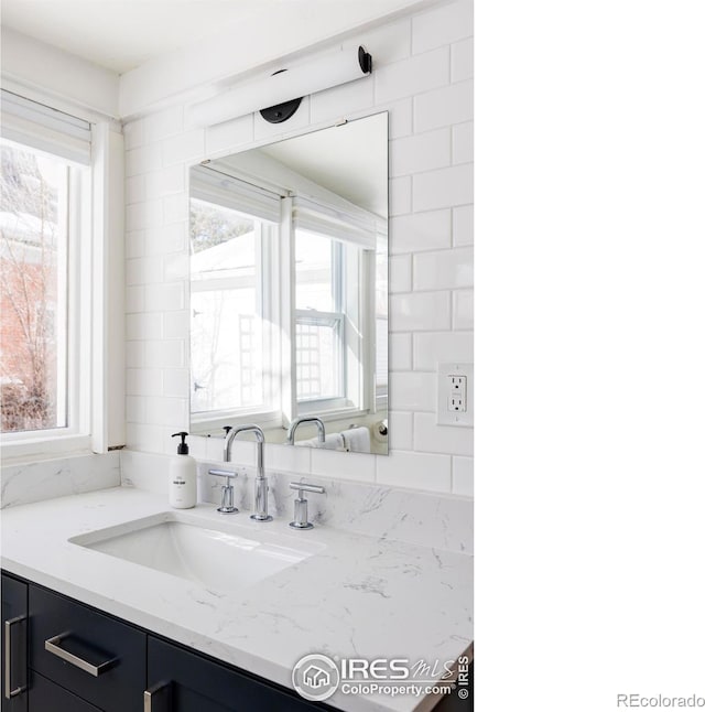 bathroom with vanity and a healthy amount of sunlight