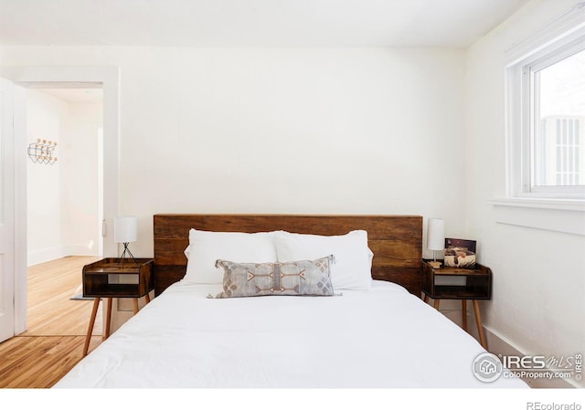 bedroom with hardwood / wood-style flooring