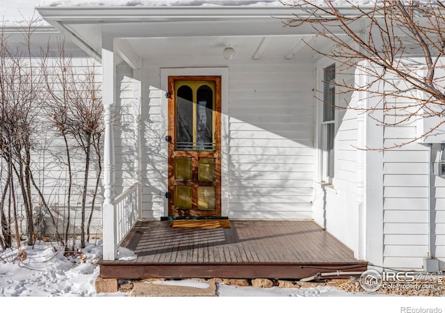 view of snow covered property entrance