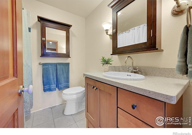 bathroom with vanity, tile patterned floors, and toilet