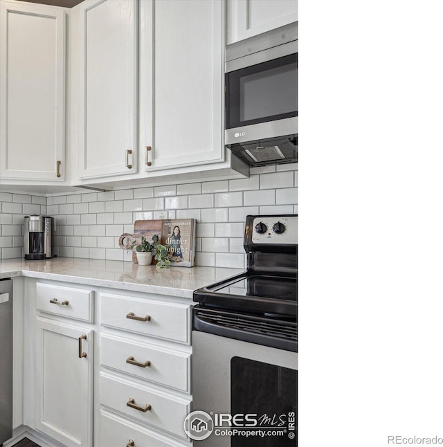 kitchen featuring white cabinetry, stainless steel appliances, and tasteful backsplash