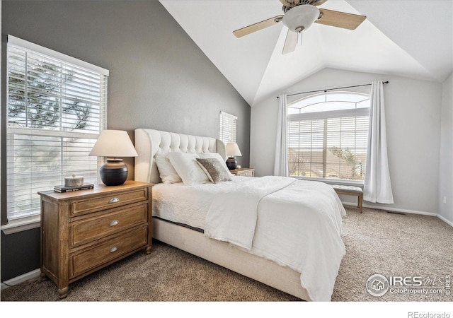 carpeted bedroom with ceiling fan and vaulted ceiling