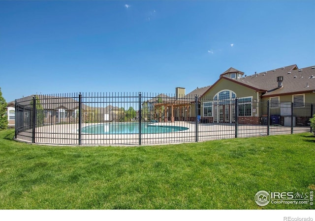 view of pool with a yard and a patio area