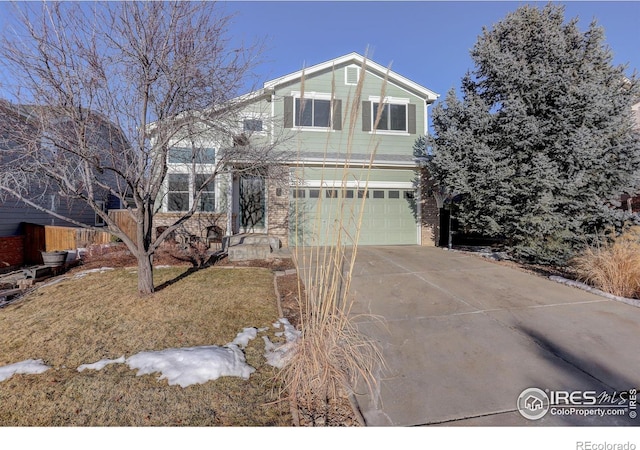 view of front of property featuring a garage and a front yard