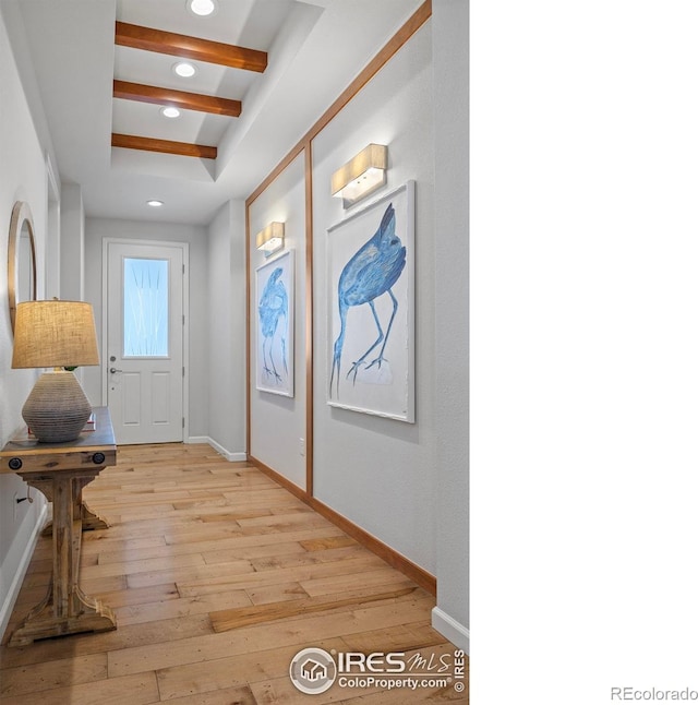 interior space with coffered ceiling, light hardwood / wood-style flooring, and beamed ceiling