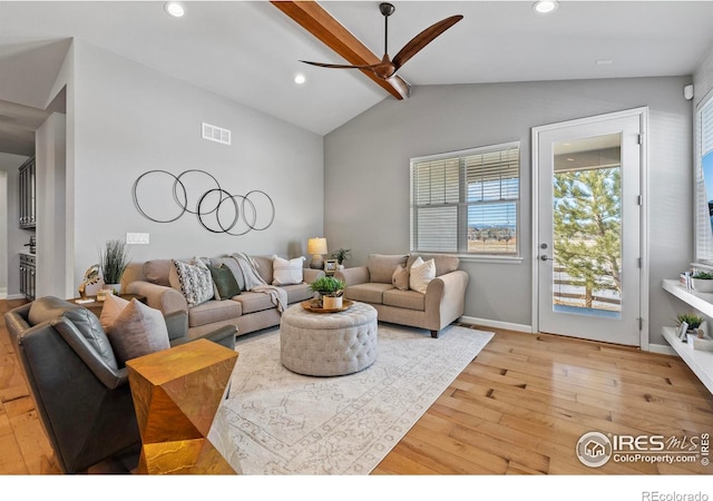 living room featuring vaulted ceiling with beams, light hardwood / wood-style flooring, and ceiling fan