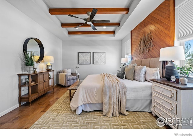 bedroom featuring beamed ceiling, ceiling fan, and light wood-type flooring