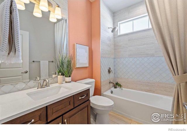 full bathroom featuring shower / tub combo with curtain, vanity, and toilet