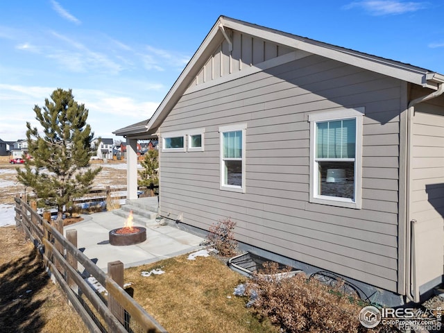 view of home's exterior with a patio area and an outdoor fire pit