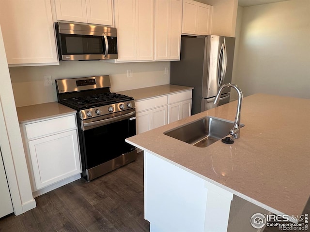 kitchen with white cabinetry, sink, dark hardwood / wood-style floors, and appliances with stainless steel finishes