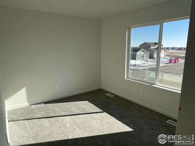 empty room featuring dark carpet