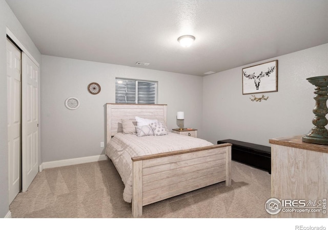 carpeted bedroom with a closet