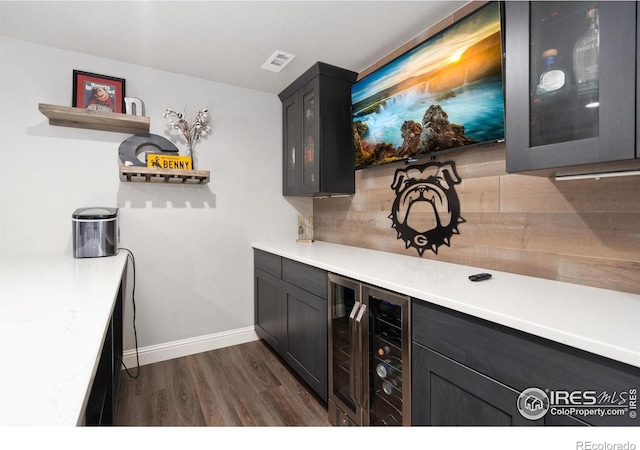 bar with dark wood-type flooring and beverage cooler