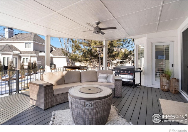 snow covered deck featuring ceiling fan, a grill, and an outdoor hangout area