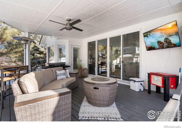 deck featuring an outdoor living space and ceiling fan