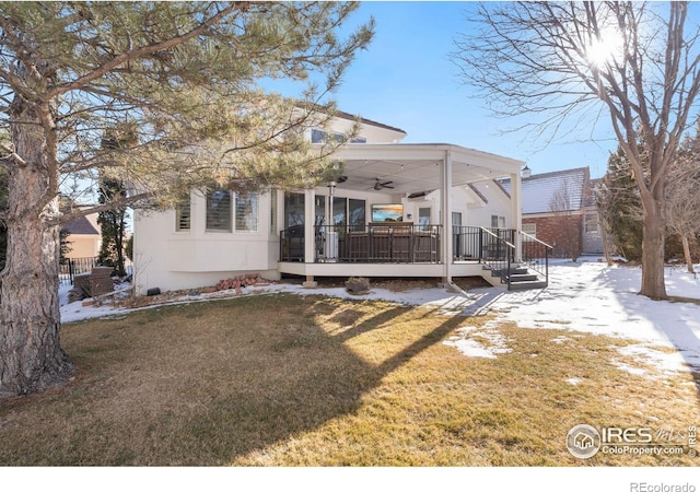 rear view of house featuring a wooden deck, a lawn, and ceiling fan