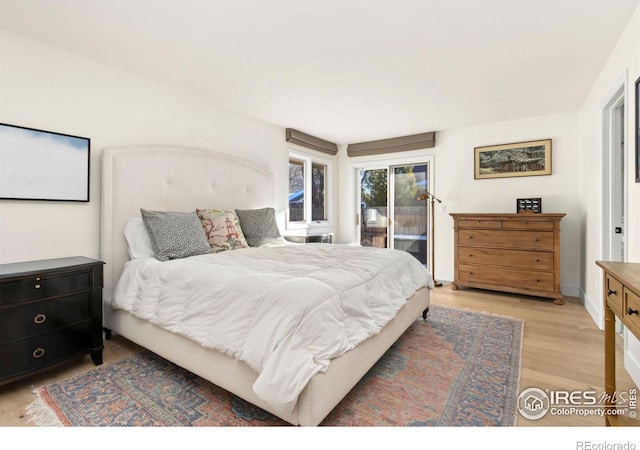 bedroom featuring access to exterior and light hardwood / wood-style floors