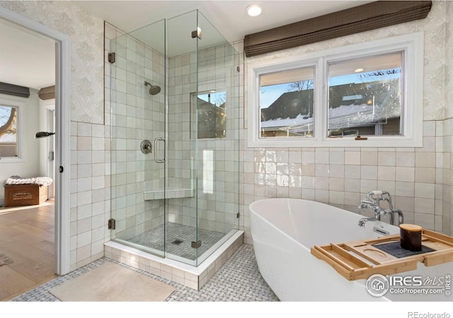 bathroom featuring separate shower and tub, tile patterned flooring, and tile walls