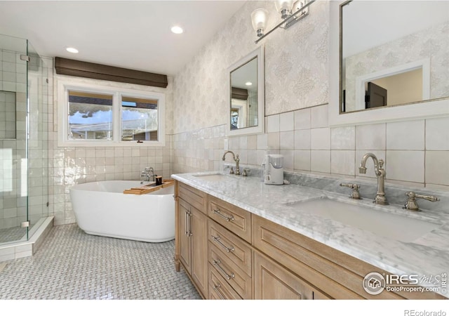 bathroom with tile walls, vanity, tile patterned floors, and independent shower and bath