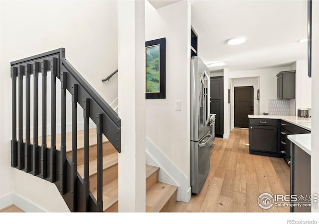 stairway featuring wood-type flooring