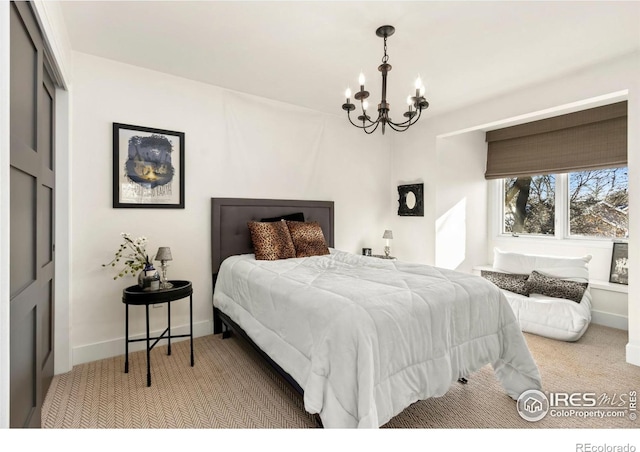 carpeted bedroom with an inviting chandelier