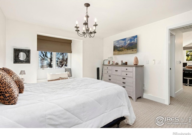 bedroom featuring light carpet and a notable chandelier