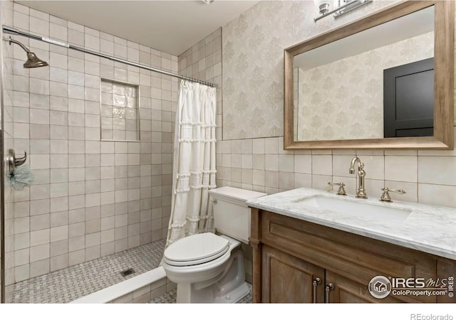 bathroom featuring vanity, toilet, tile walls, and a shower with curtain