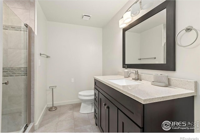 bathroom featuring vanity, an enclosed shower, tile patterned flooring, and toilet