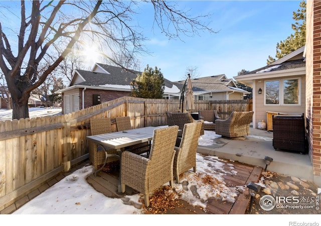 snow covered deck featuring an outdoor living space