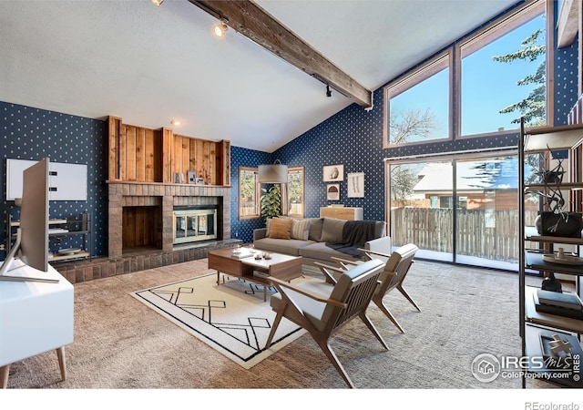 carpeted living room featuring high vaulted ceiling, a textured ceiling, a fireplace, and beam ceiling