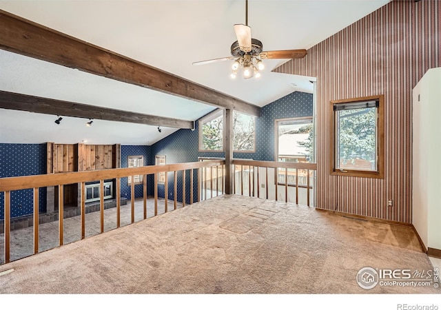 bonus room with ceiling fan, lofted ceiling with beams, a healthy amount of sunlight, and carpet flooring