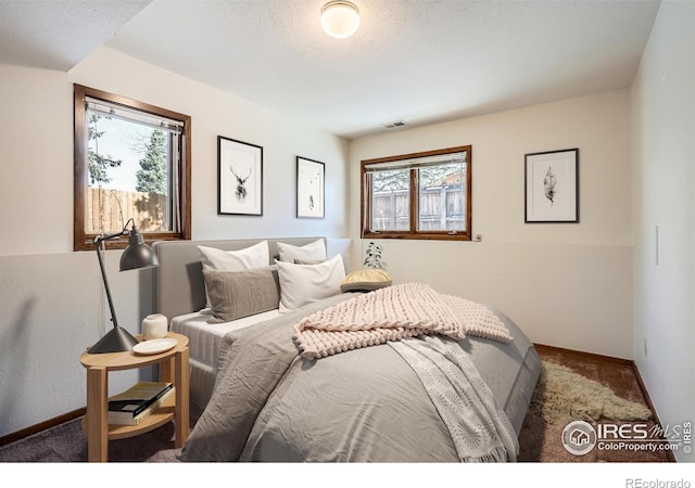 carpeted bedroom with a textured ceiling