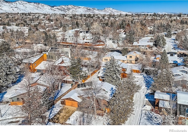 snowy aerial view with a mountain view