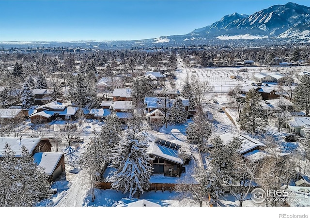 snowy aerial view with a mountain view