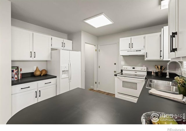 kitchen with sink, white cabinets, and white appliances