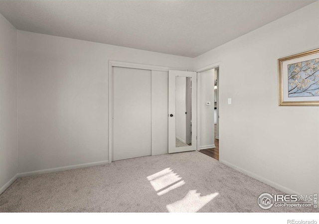 unfurnished bedroom featuring carpet floors and a closet