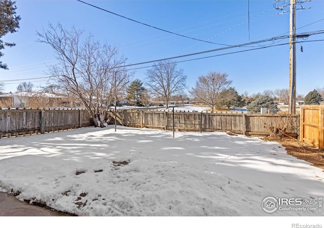 view of yard layered in snow