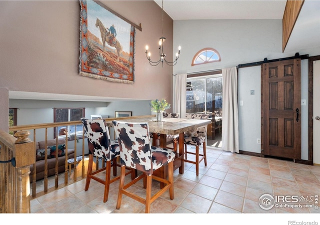 tiled dining area featuring a barn door, a notable chandelier, and high vaulted ceiling